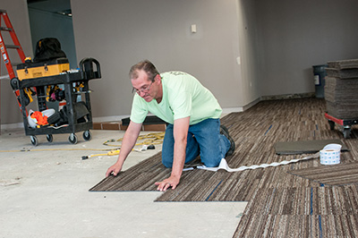 man installing flooring