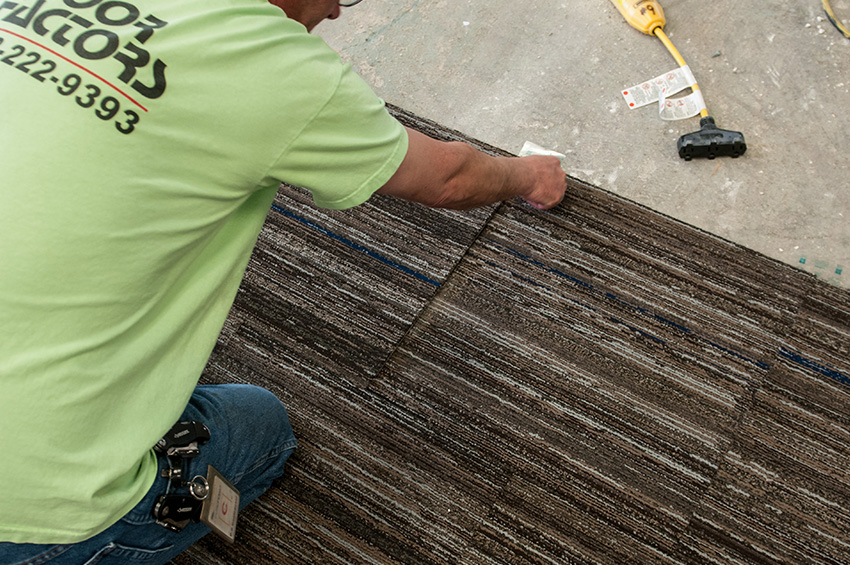 man-installing-carpet-over-concrete