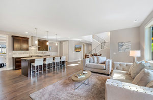 Open concept living room and kitchen with new hardwood flooring.