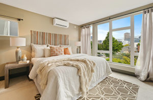 Warm beige carpet with tan area rug in a master bedroom