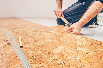 An installer from Floor Factors in Portland works on the installation of Amorim's Cork Pure Signature Floor and Wall material.