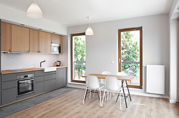 The flooring in this small kitchen matches the cabinets and countertops.