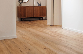 Light oak wood-look cinyl plank flooring in a home foyer.