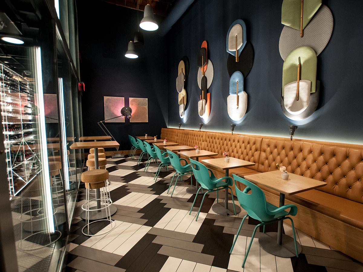Hip eatery with multi-colored tile sloors, creative lighting, and brightly colored art.
