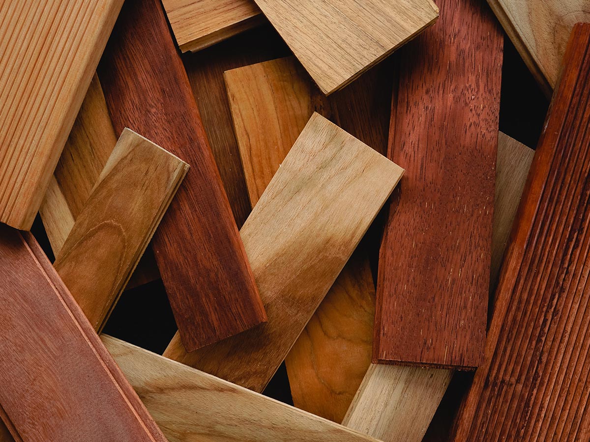 A variety of hardwood flooring planks in various hues and grains.