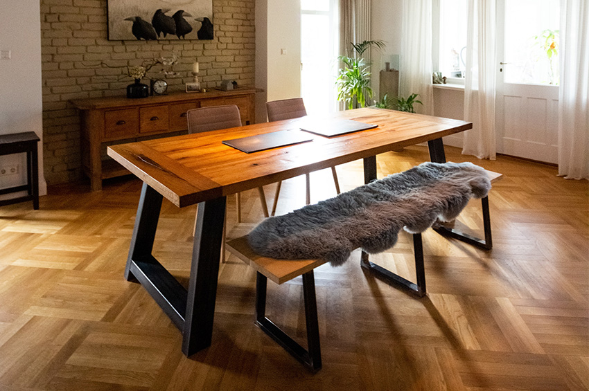 Oak hardwood flooring in a dining room with a wood table, bench, and other home decor.