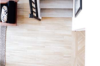 Very light toned hardwood oak floors at the end of a stairway landing.