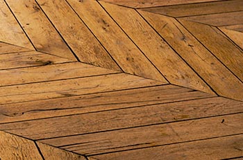 Light colored hardwood flooring in a herringbone pattern.