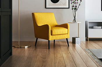 A living room showcases new bamboo flooring, a yellow chair, and brass lamp.