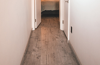 A hallway showcases wood-look vinyl plank flooring.