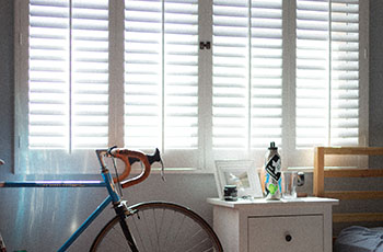 Light-blocking Hunter Douglas shutters featured in a kid's bedroom.