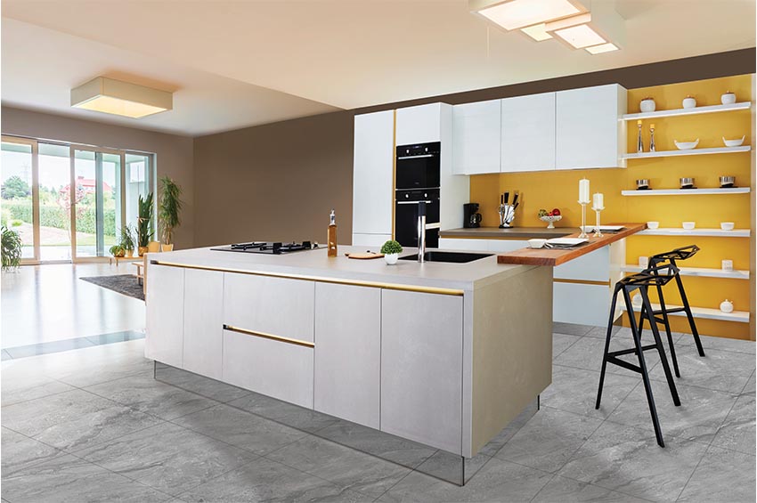 This clean, modern kitchen design features large format gray tile, sleek white countertop, and bright yellow walls.