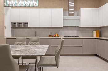 This small kitchen looks larger thanks to a monochrome palette in beige.