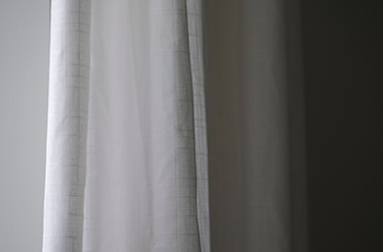 Close up shot of a dark curtain with a white backing.